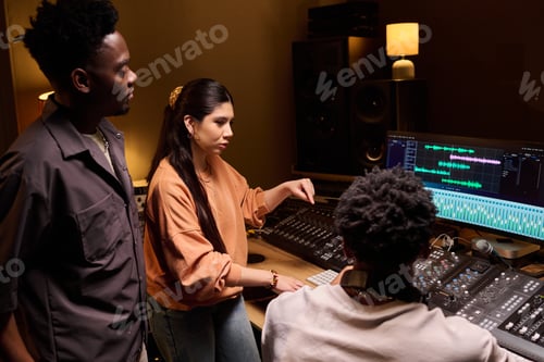 Preview: Young Multiethnic Music Producers Collaborating in Professional Recording Studio