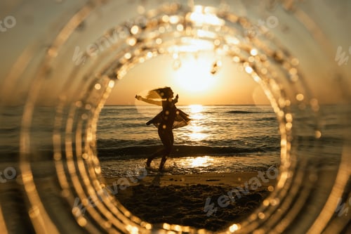 Preview: Woman Dancing at Sunset on a Beach
