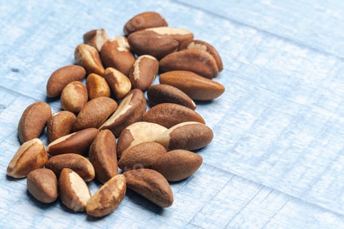 Preview: Pile of brazil nuts on wooden surface