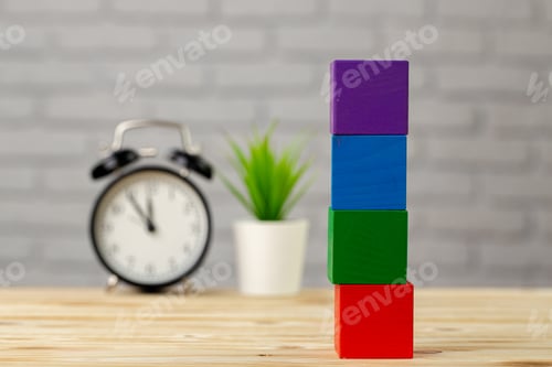 Preview: Four wooden cubes with copy space and alarm clock