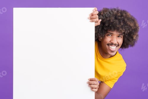 Preview: Smiley african man with curly hair holding a blank panel