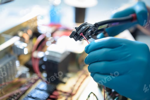 Vista previa: Worker assembling electronics in electronics factory, focus on hands