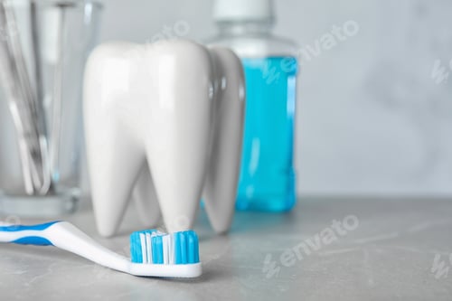 Preview: Brush and tooth shaped holder on table, space for text. Professional dentist