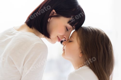 Preview: Mother and daughter sharing tender forehead touch moment