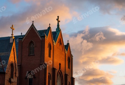 Preview: Catholic church against the sky during sunset