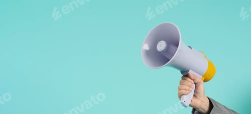 Preview: Hand is hold megaphone and wear grey suit on mint green or Tiffany Blue background.