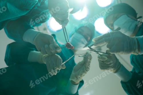 Preview: Medical team of surgeons in hospital doing invasive surgical interventions