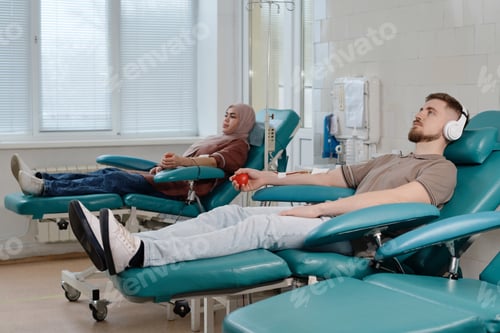 Preview: Medical Center Visitors Donating Blood Laying on Procedure Chairs