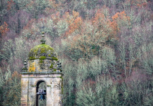 Preview: Old mossy stone bell tower in a rural church