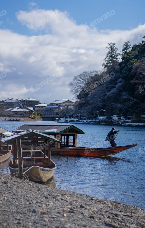 Preview: Man rowing a wooden boat