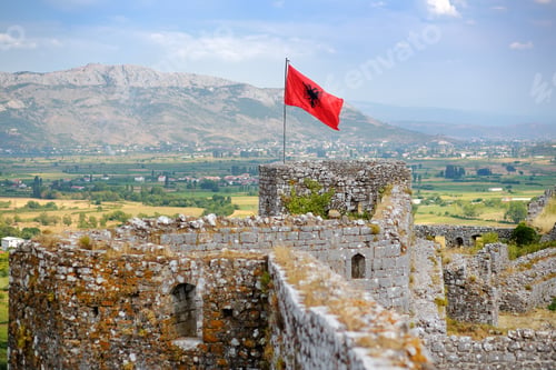 Preview: Red Albanian flag with black eagle waving over wall of Fortress Rozafa near Shkodra city