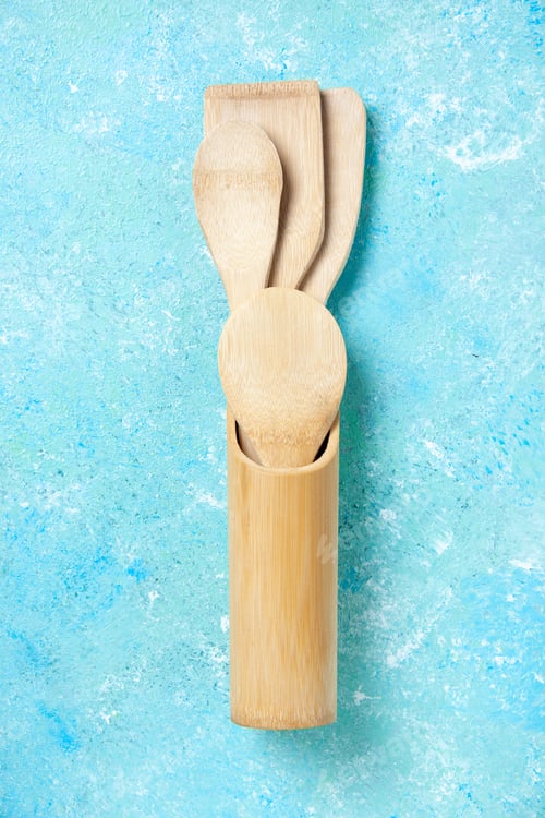 Preview: top view various wooden spoons in upright spoon rest on table