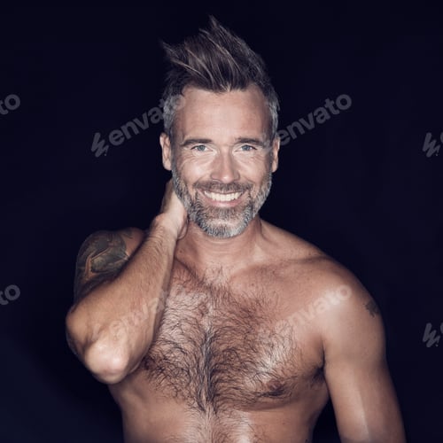 Preview: Macho and rugged. Portrait of mature man posing against a dark background.