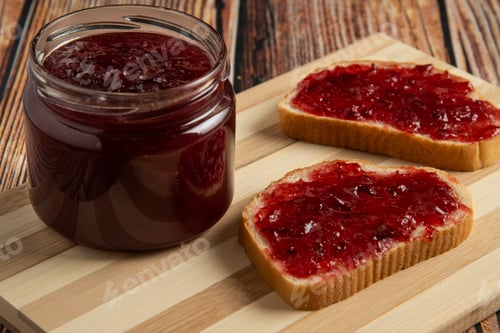 Preview: Plum confiture in the glass jar and on the toast