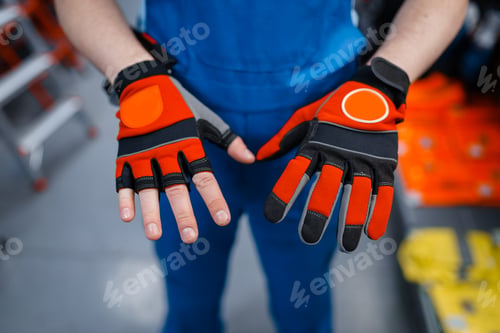 Preview: Male worker hands in protective gloves, tool store