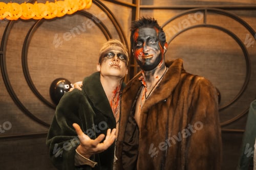 Preview: Friends in costumes at the halloween party with friends in a disco nightclub