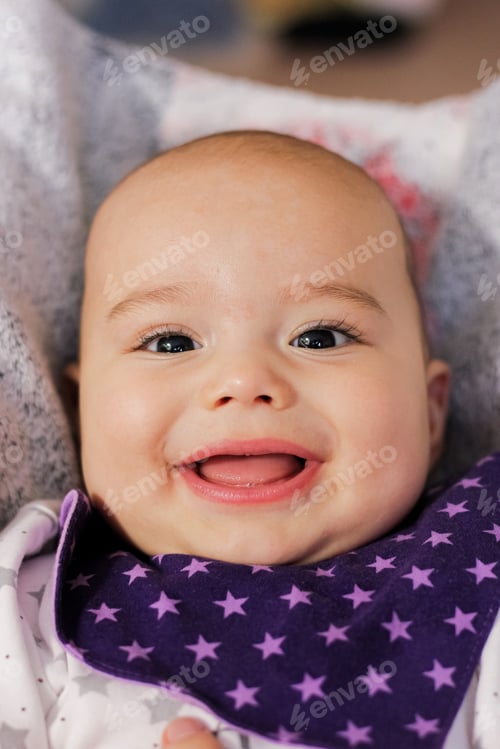 Preview: Very happy smiling infant looking to camera close-up
