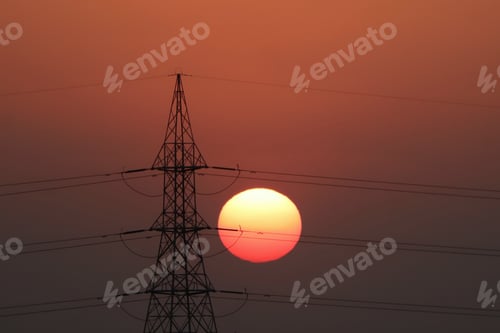 Preview: Silhouette shot of a transmission tower during a red sunset