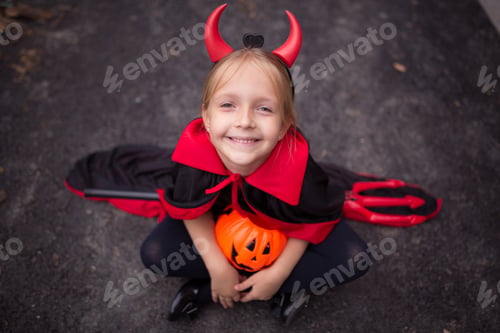 Preview: Happy kid in evil costume for Halloween 2021 during coronavirus covid-19 pandemic