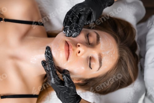 Preview: Portrait of a young woman undergoes face massage in a beauty salon