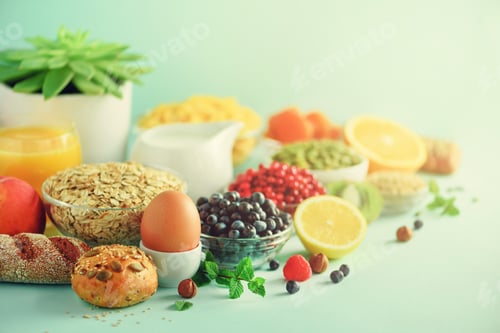 Preview: Delicious breakfast ingredients. Soft boiled egg, oat flakes, nuts, fruits, berries, milk, yogurt