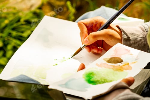 Preview: Artist Hand Painting Green Watercolor Landscape Outdoors