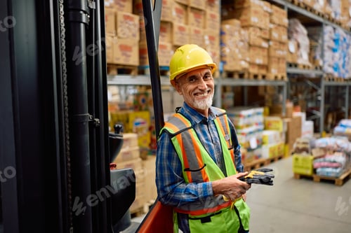 Preview: Happy senior forklift operator working at distribution warehouse and looking at camera.