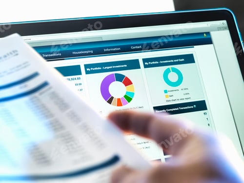 Preview: Investor checking performance of financial portfolio online whilst reviewing investment statement