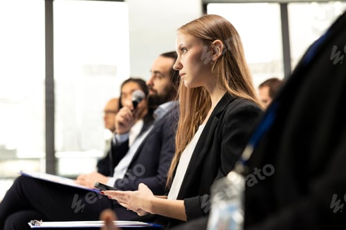 Preview: Young adult female attends professional business event in conference room
