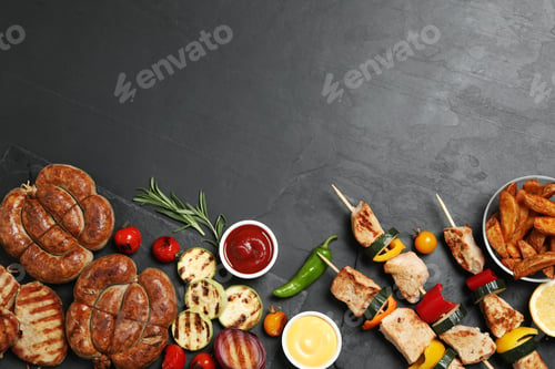 Preview: Flat lay composition with barbecued meat and vegetables on grey table. Space for text