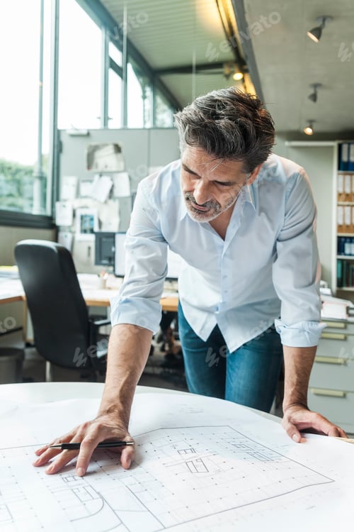 Preview: Architect working on ground plan in office