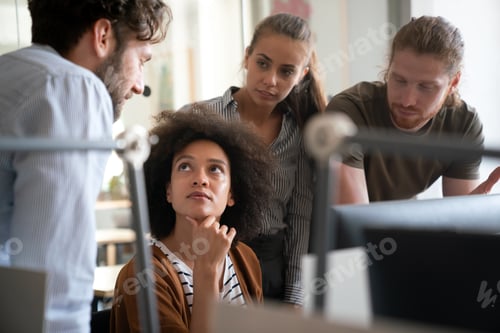 Preview: Smiling diverse colleagues gather in boardroom brainstorm discuss financial statistics together