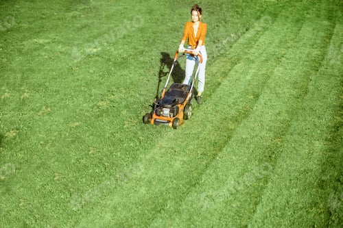 Preview: Woman cutting grass with lawn mower