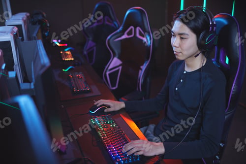 Preview: Asian Man Playing Video Games in Computer Club