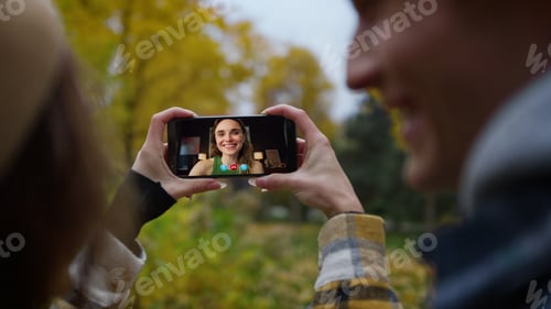 Preview: Couple calling happy friend online outside closeup. Smiling woman sharing news