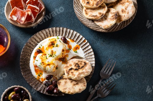 Preview: Cilbir or Turkish Eggs. poached eggs topped over herbed greek yogurt