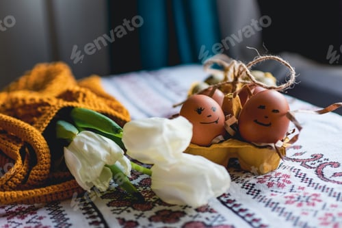 Preview: Easter eggs on rustic table with white tulips