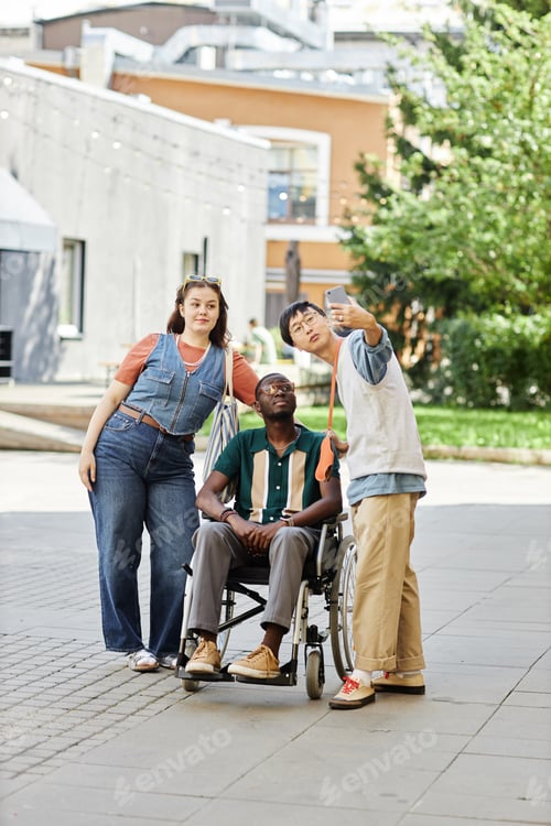 Preview: Black Man using Wheelchair Taking Selfie Photo with Friends
