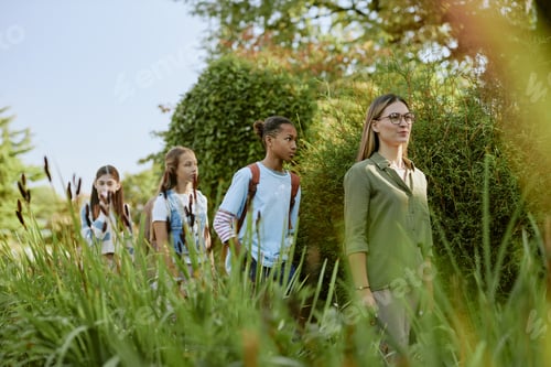 Preview: Woman Showing Botanical Garden To Teenagers