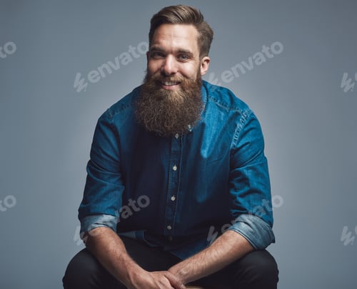Preview: Handsome smiling man in blue shirt and beard
