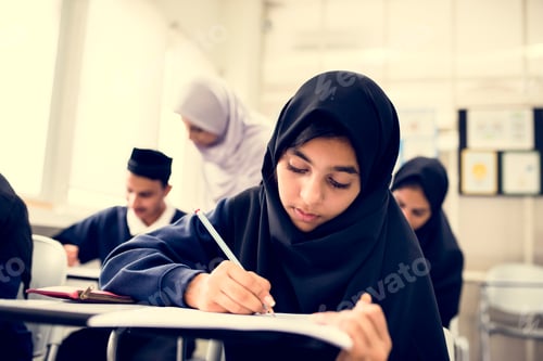 Focused Students Study Together in Bright Classroom
