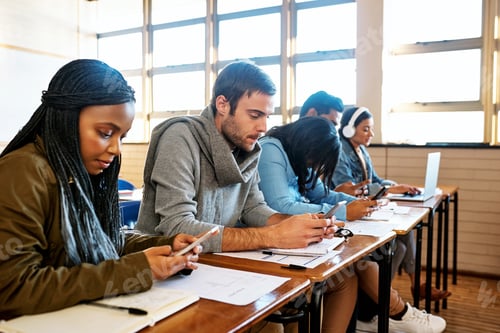 Preview: Cropped shot of a group of young university students working in class
