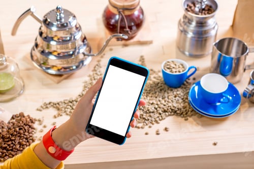 Preview: Holding smart phone on the coffee bacground