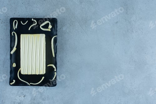 Preview: Sliced cheese on a platter on marble background