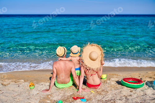Preview: Family On Beach With Inflatable Ring And Toys. Young Couple With Three Year Old Boy. Summer Family