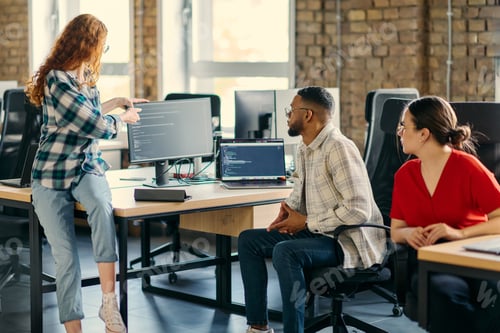 Preview: A diverse group of young business individuals congregates in a modern startup coworking center