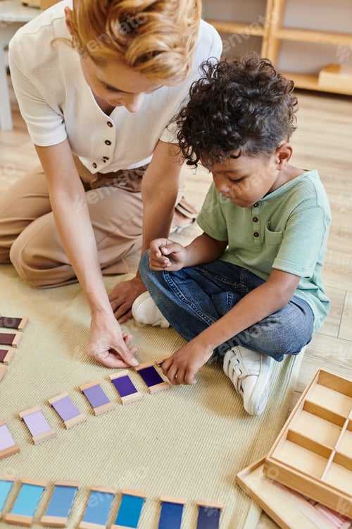 Preview: montessori color box, material touch box, blonde woman and african american boy, teacher, kid