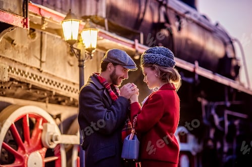 Preview: Portrait of a young man and a girl. Date night at the train station.