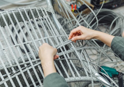 Preview: rattan furniture, a woman makes an artificial rattan chair. handmade