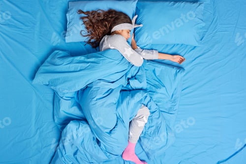 Preview: Serene millennial woman rests in bedroom enjoys fresh bedclothes has sweet dreams wears pajama sleep